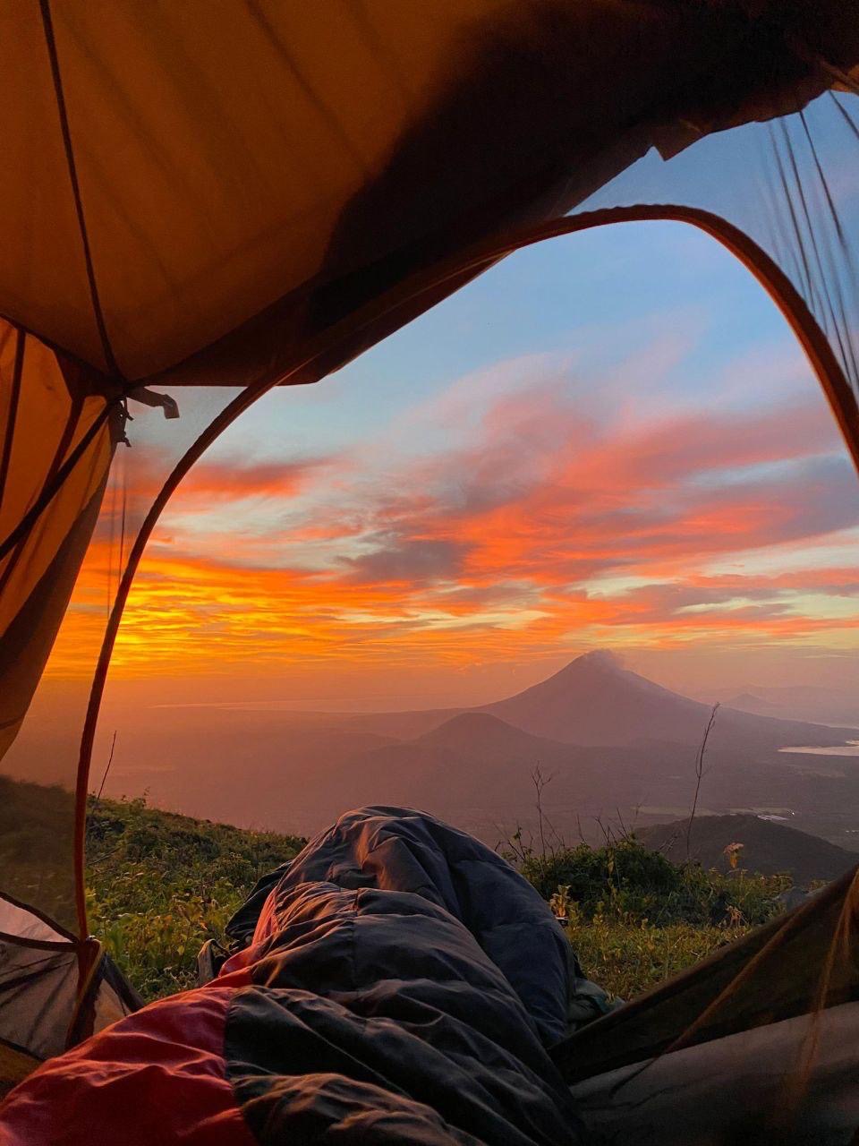 View from inside tent at El Hoyo camp with Momotombo volcano at sunrise