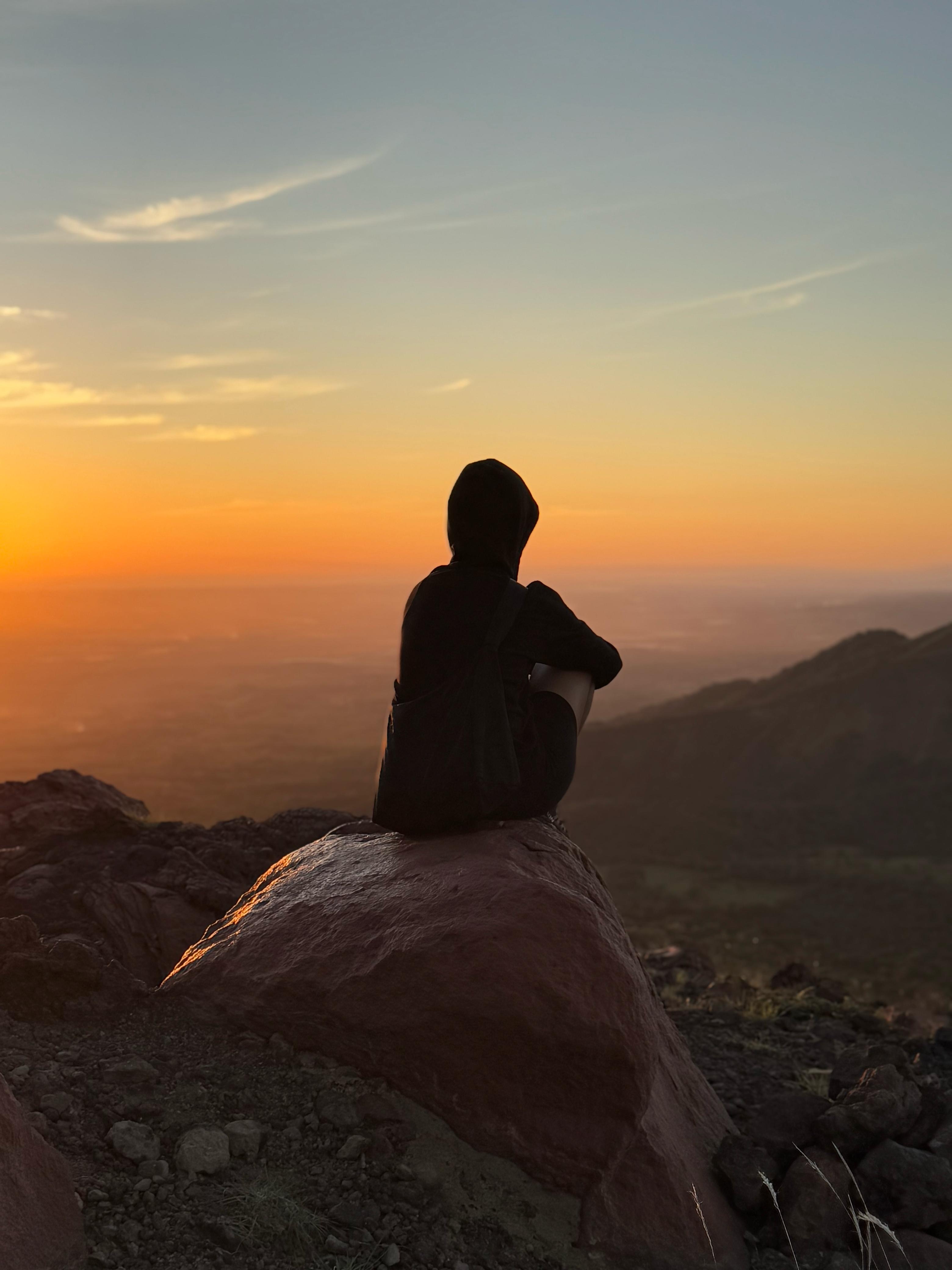 Traveler watching the sunset from Telica Volcano viewpoint