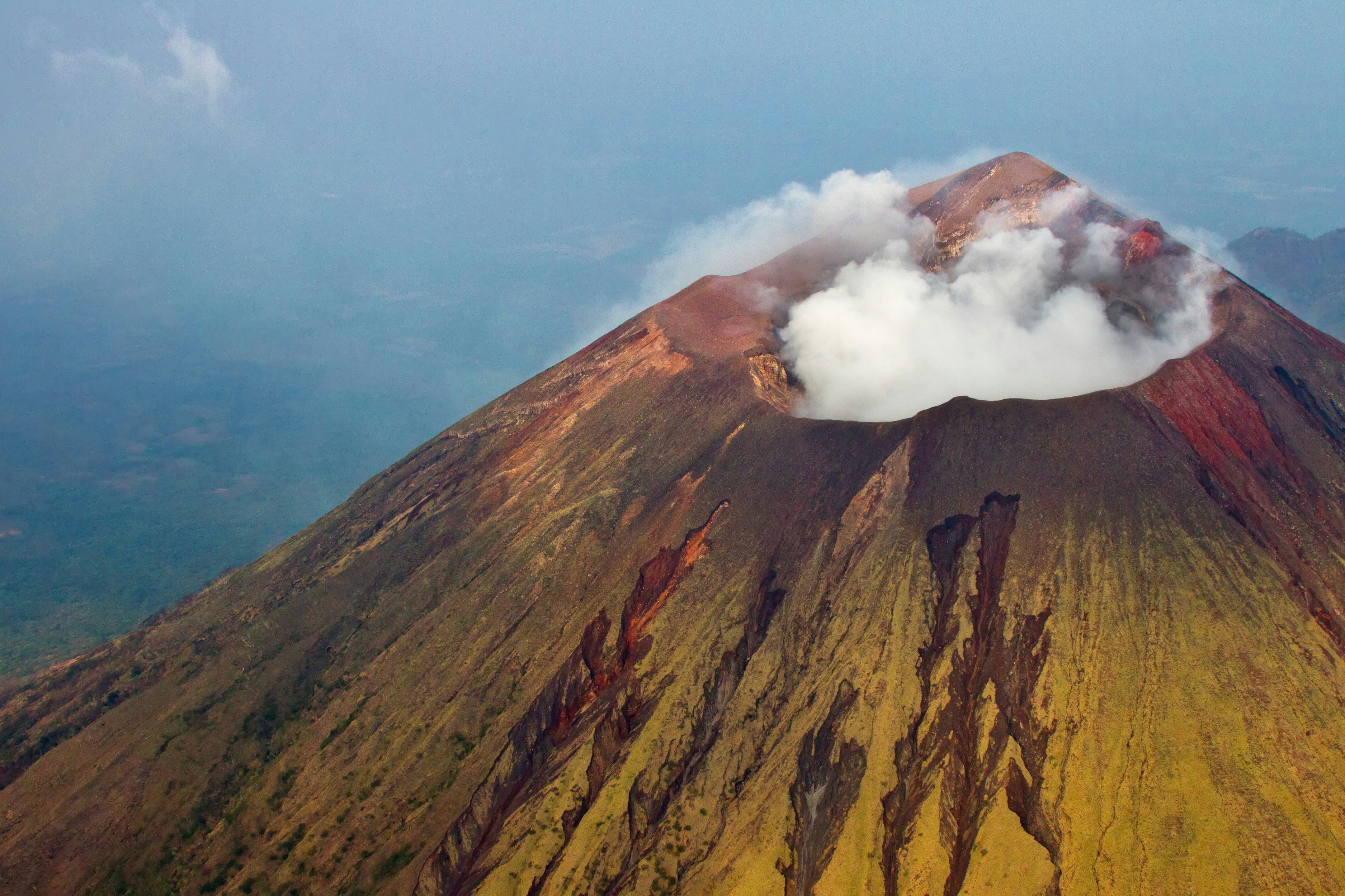 Active volcano with steam vents and colorful mineral deposits in Nicaragua's volcanic chain